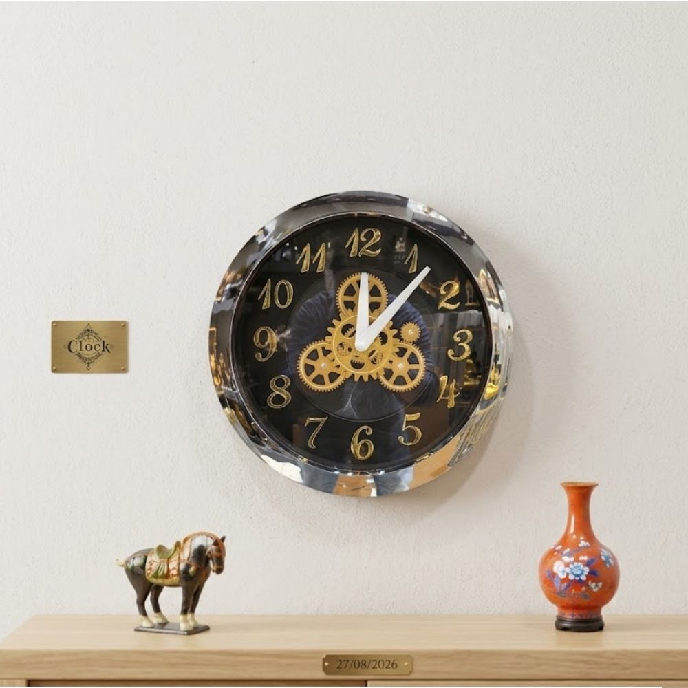 Round black wall clock with a polished chrome silver rim, white hands, golden numbers, and central gold mechanical gears.