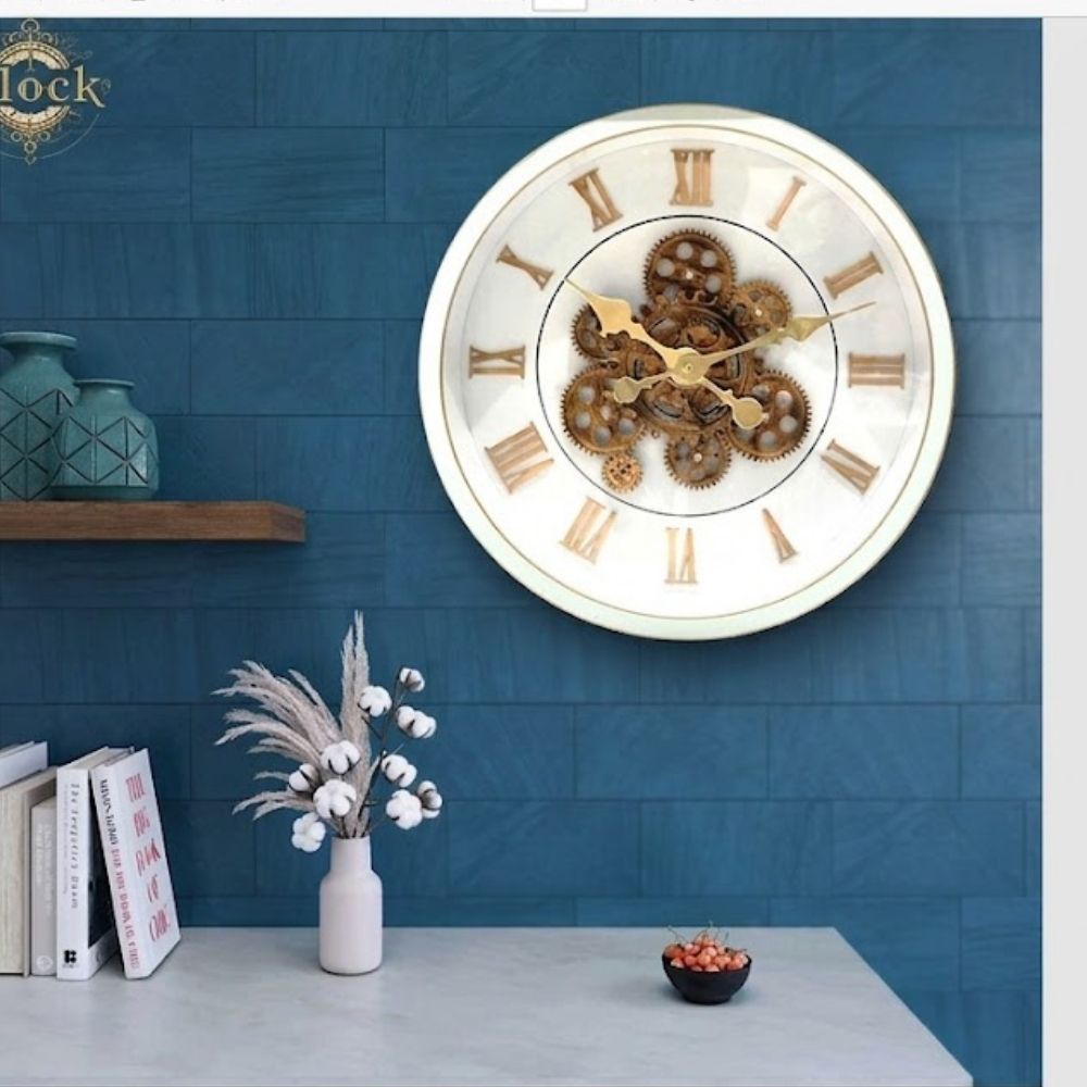 Round wall clock featuring a clean white dial, golden Roman numerals, a white rim, and visible rustic gold central gears.