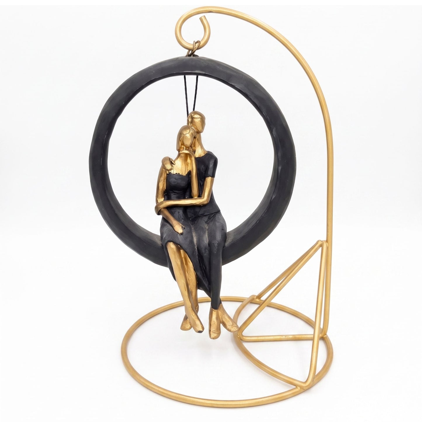 Abstract gold and black couple sitting together on a circular hanging swing with a metallic golden stand.
