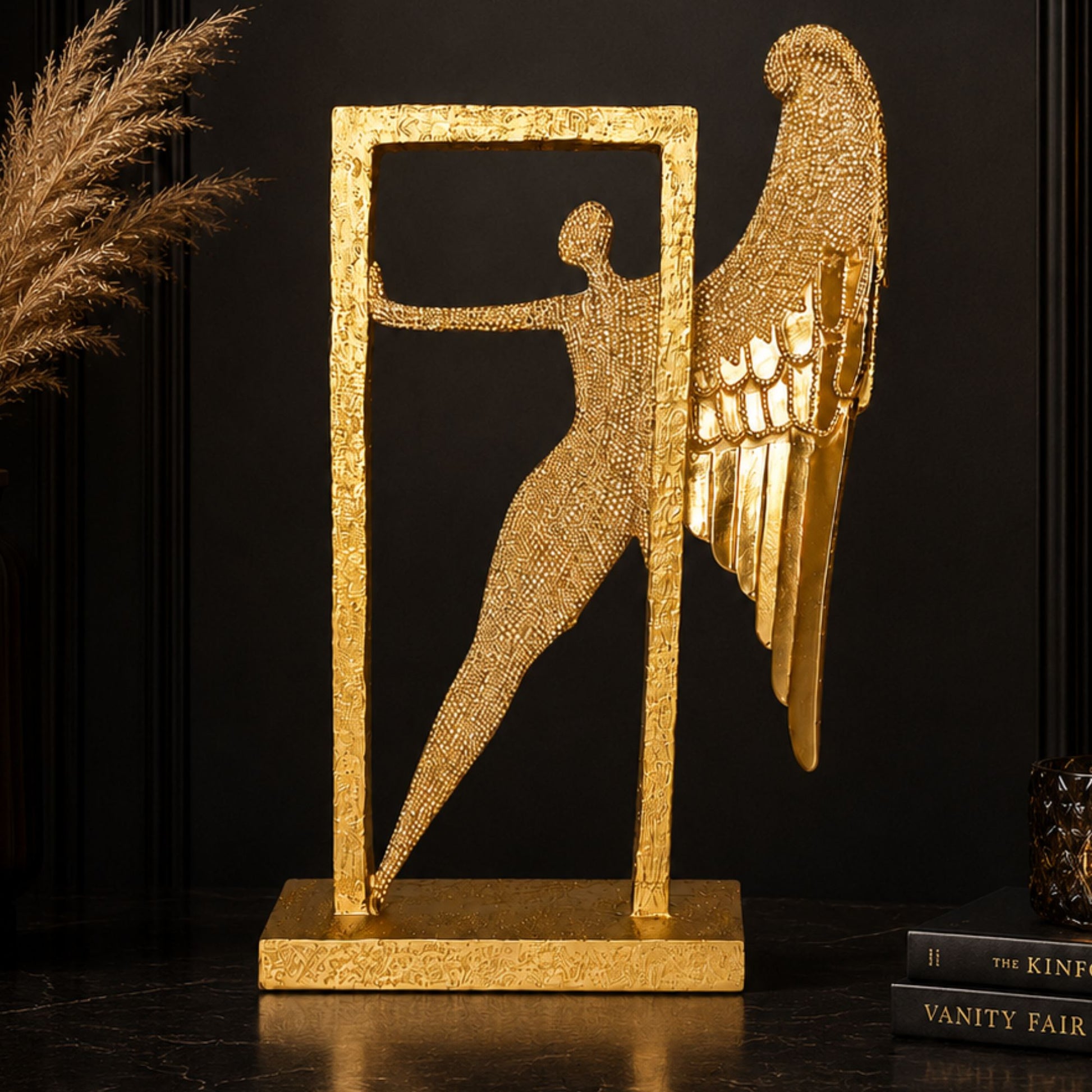 Abstract textured golden angel figure with wings posing inside a matching gold frame for luxury tabletop decor.
