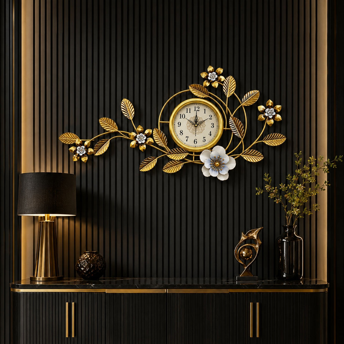 Asymmetrical metal wall clock with gold branches, leaves, small flowers, and a large white bloom framing a central gold dial.