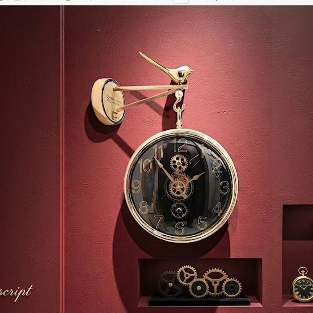Double-sided hanging station wall clock featuring a black dial, gold numerals, and visible central gears, suspended from a golden bird-motif bracket against a deep red wall background.