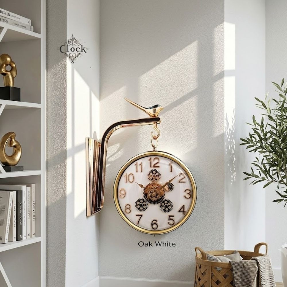 Double-sided hanging station wall clock with an oak white dial, golden numbers, and moving central gears, suspended from a decorative bird-motif bracket in a modern living space.