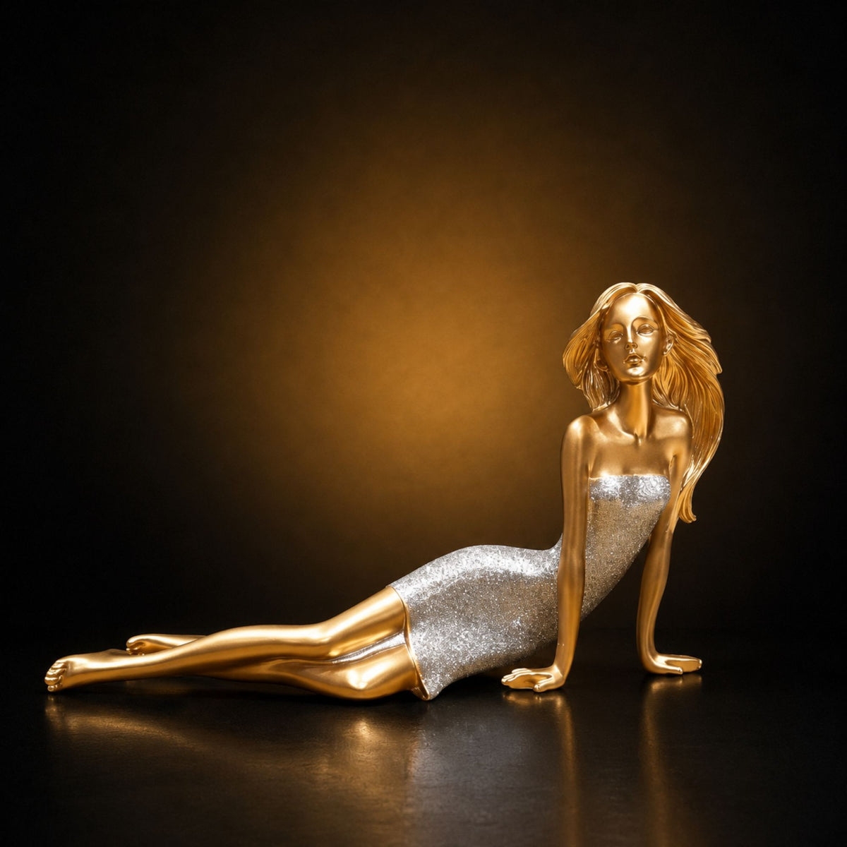 Golden reclining lady statue leaning on hand in silver glitter dress