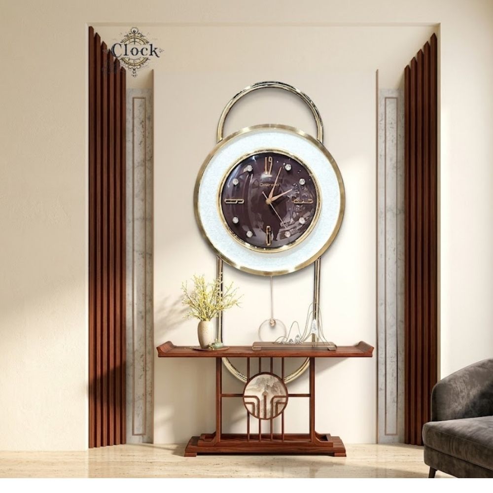 Large modern wall clock featuring a dark brown marble-textured dial with crystal markers, surrounded by a sparkling white outer ring and framed inside a tall golden arch with a slender pendulum.