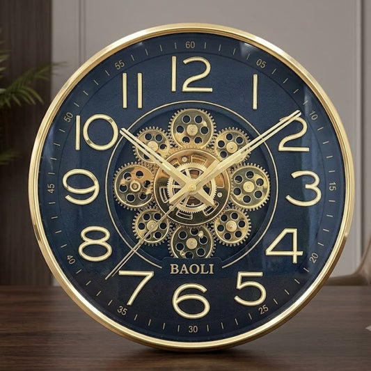 Round black wall clock featuring a polished gold rim, golden numbers, and intricate gold mechanical gears in the center.