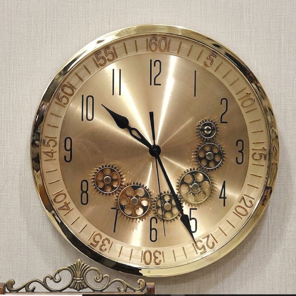 Round metallic wall clock with brushed brass finish and visible vintage gears on the dial.-1