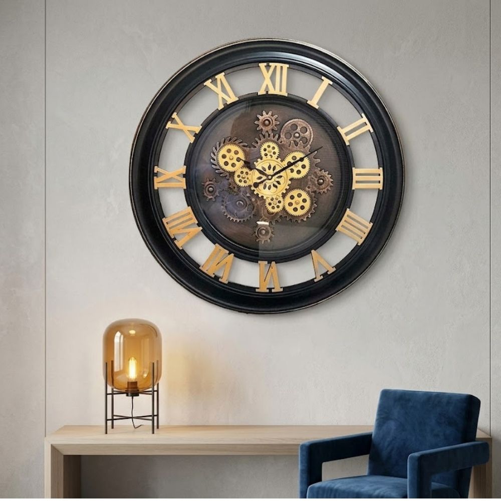 Round skeleton wall clock featuring a thick black outer rim, bold golden Roman numerals, transparent cutouts, and multi-tone golden exposed gears in the center.