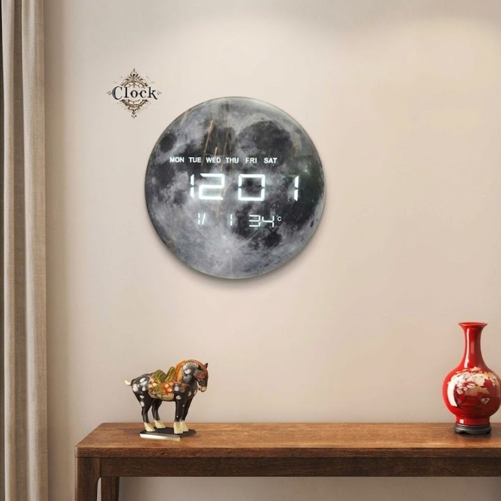 Round wall clock with a textured moon face displaying LED time, days of the week, date, and room temperature.
