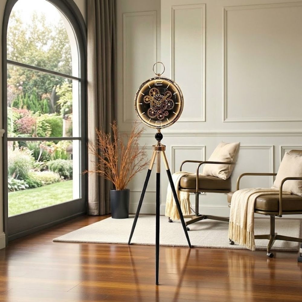 Standing tripod floor clock with black-gold legs and visible gears on a dark dial.