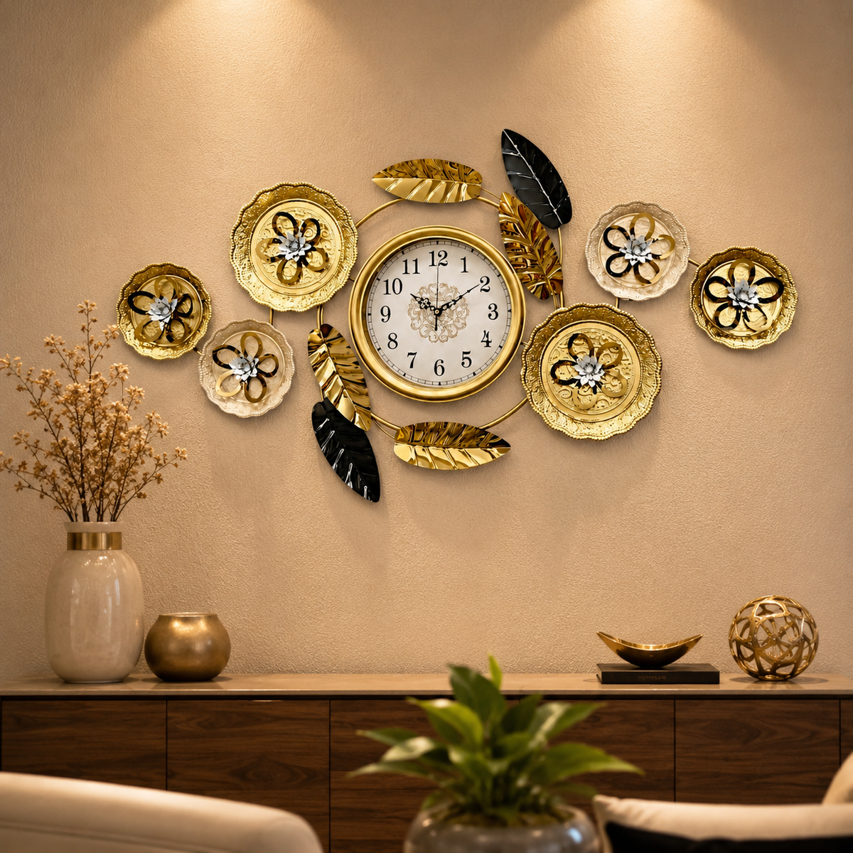 Wide metal wall clock with central gold dial, gold and black leaves, and decorative floral plates.