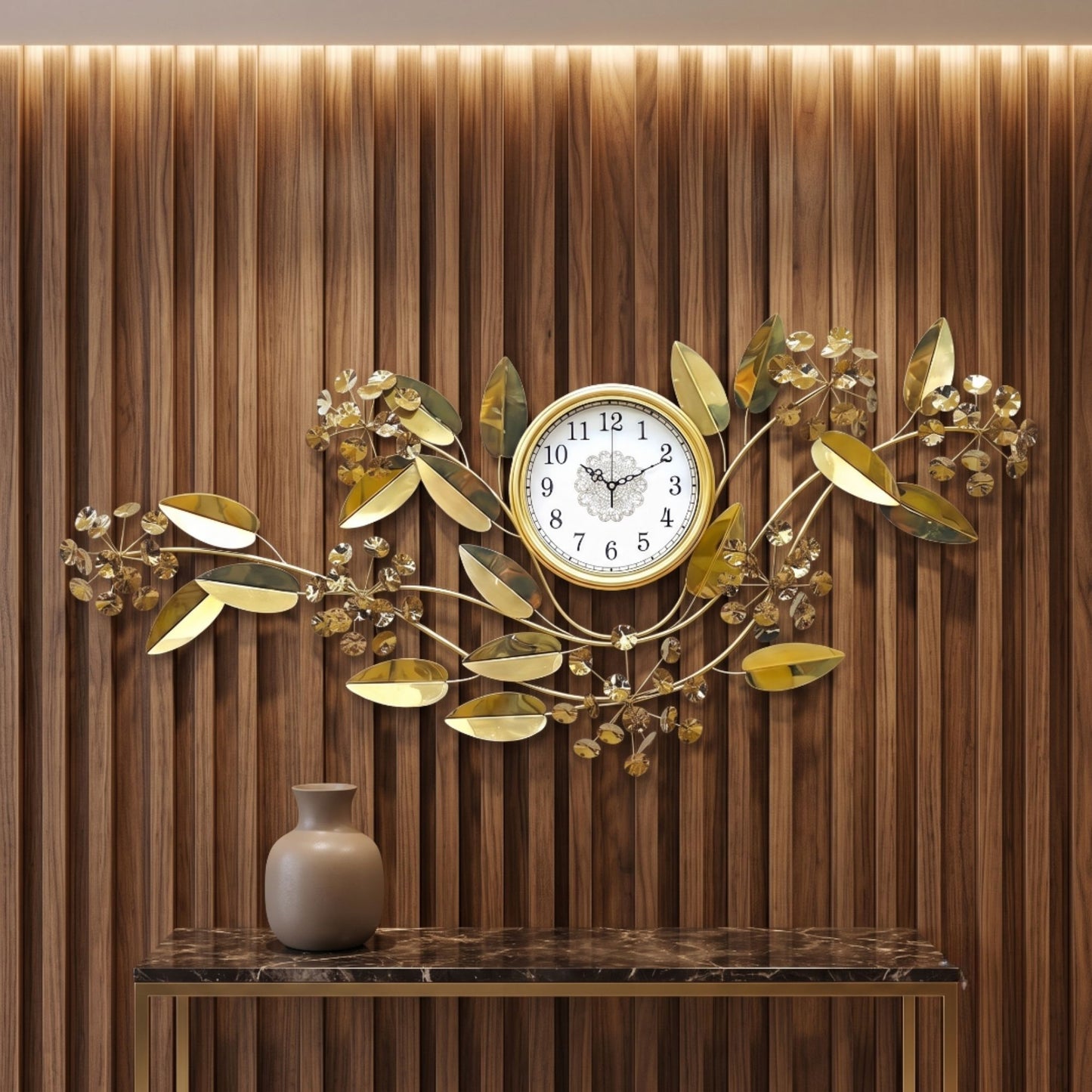 Wide metallic gold wall clock featuring delicate spreading branches, leaf accents, small floral clusters, and a round central dial.