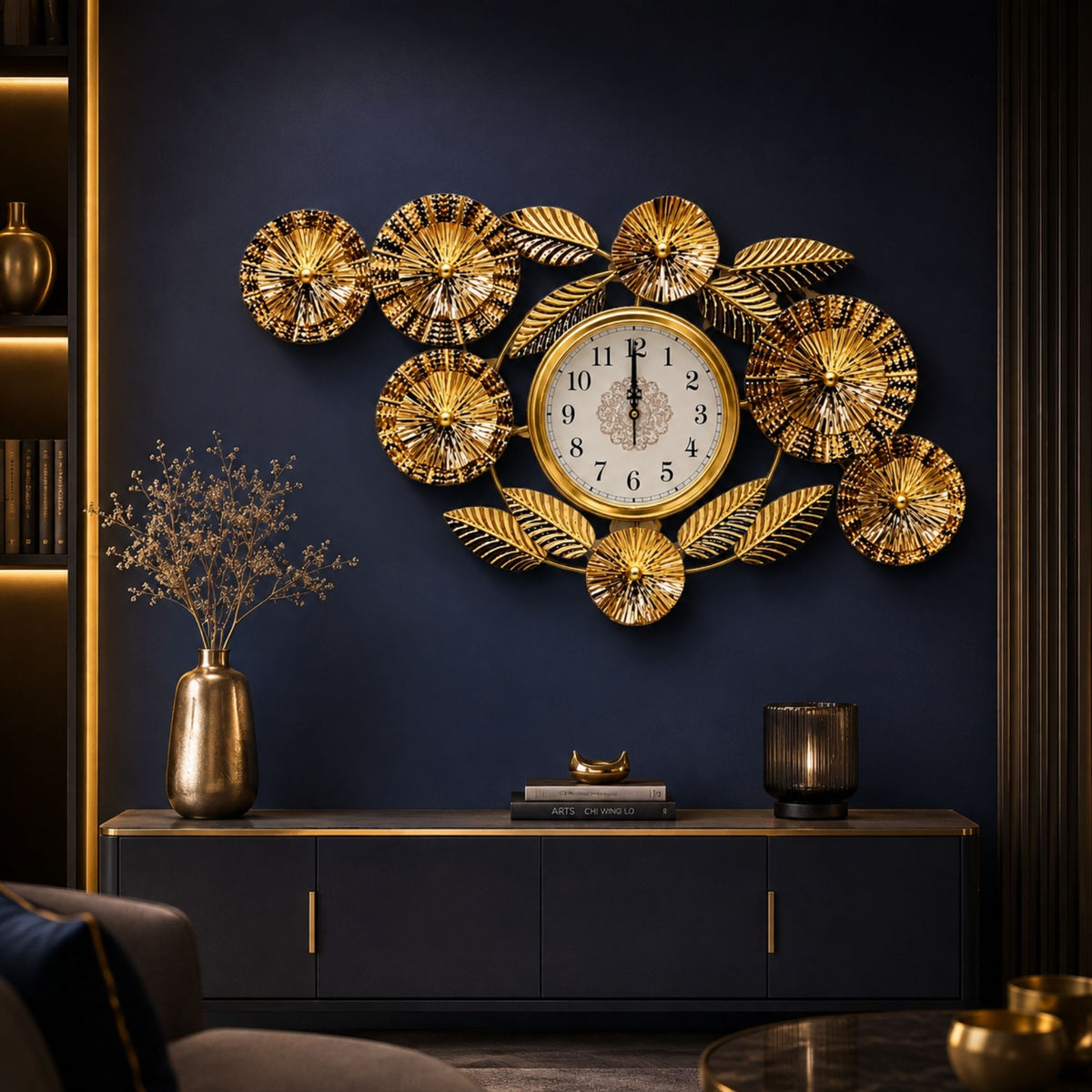 Wide metallic gold wall clock with central dial, surrounded by textured sunburst discs and detailed leaves.